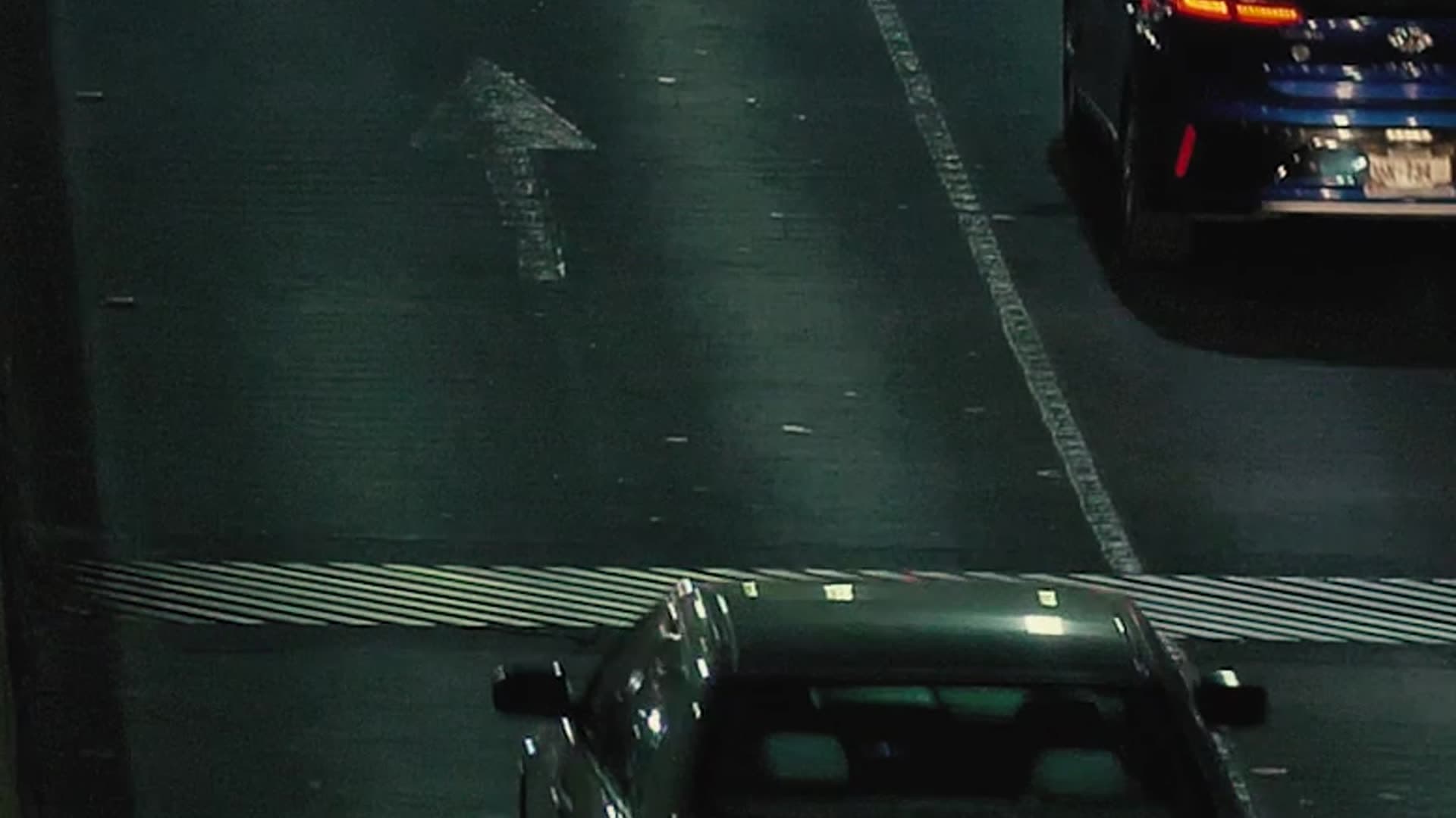 Cars moving through a city road at night
