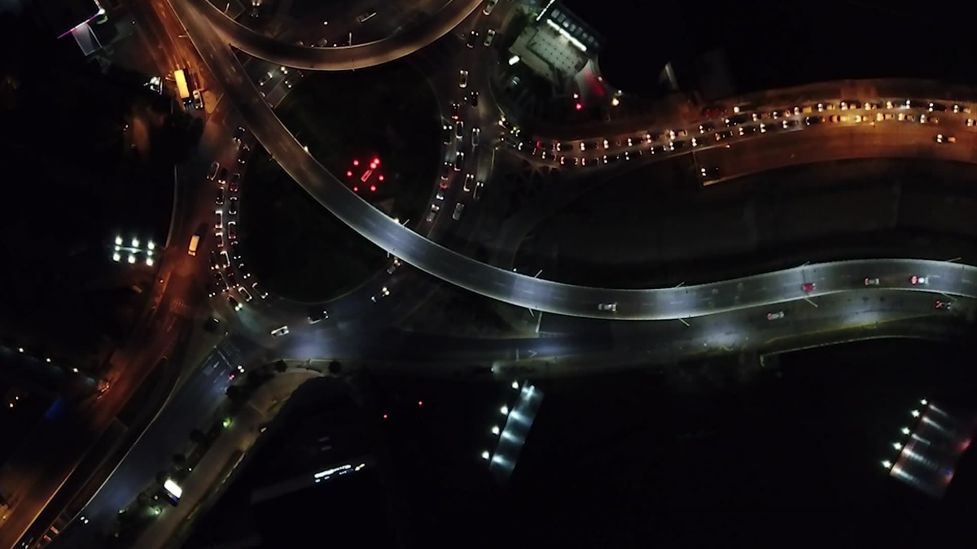 Aerial view of curving illuminated roads at night