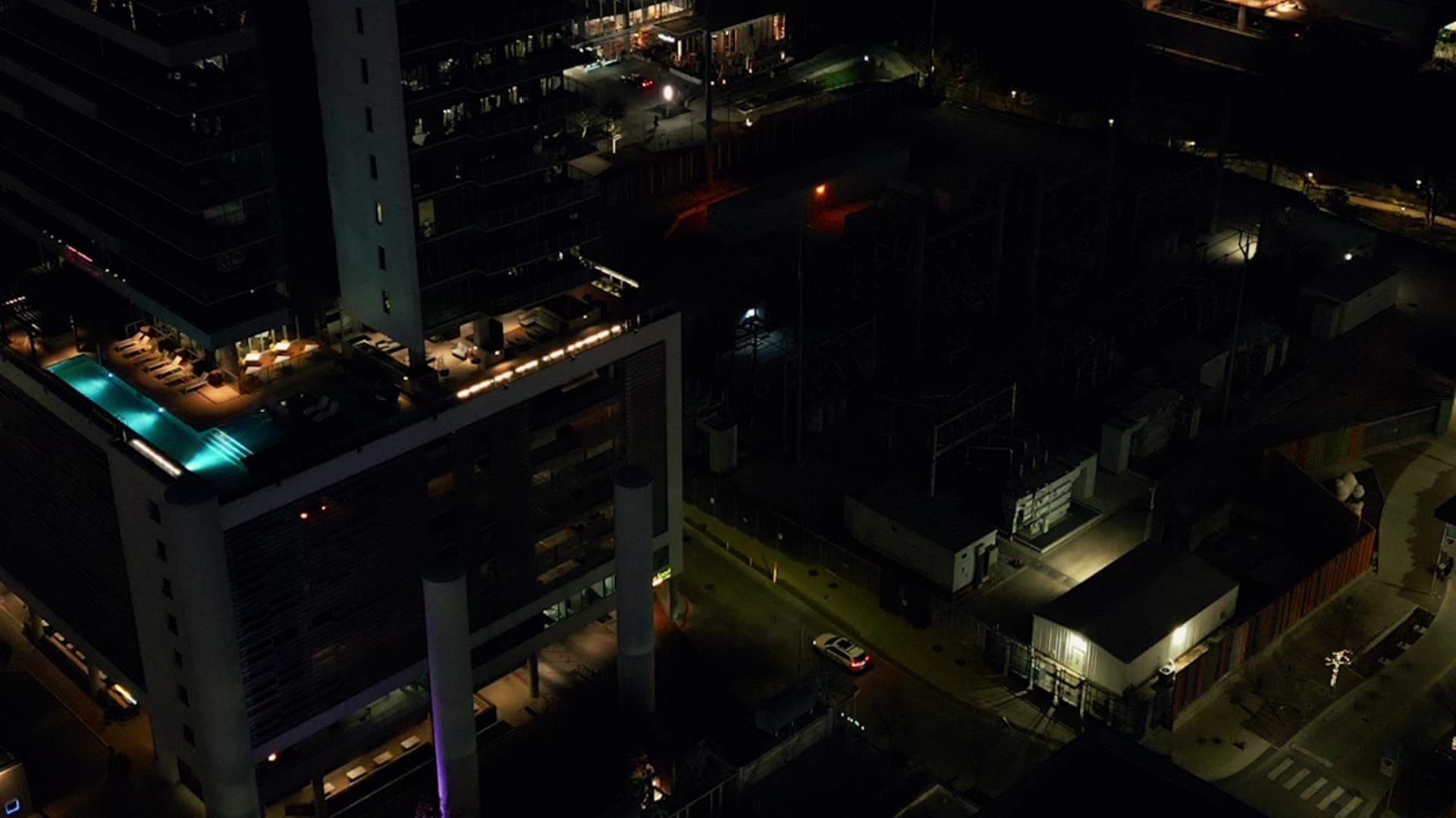 Rooftops and buildings at night viewed from above